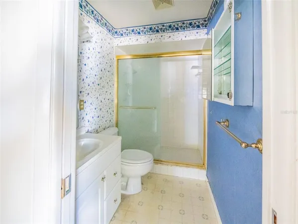 a bathroom with a toilet sink and shower