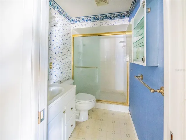 a bathroom with a toilet sink and shower