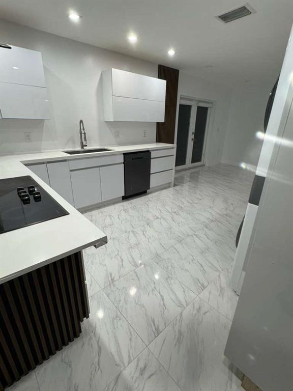 641 Southwest 35th Avenue Miami, FL 33135 - Photo 11 of 25 a kitchen with stainless steel appliances a sink dishwasher stove refrigerator and cabinets