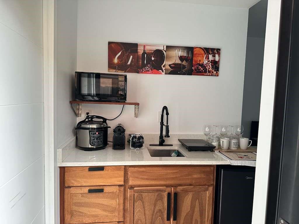 641 Southwest 35th Avenue Miami, FL 33135 - Photo 24 of 25 a kitchen with a sink and a stove with wooden floor