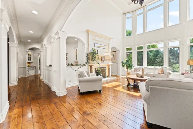 an empty room with wooden floor and a window