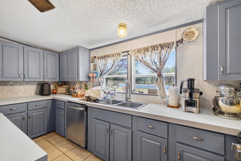 5280 Golddust Road Spring Hill, FL 34609 - Photo 11 of 41 a kitchen with a sink a window and cabinets