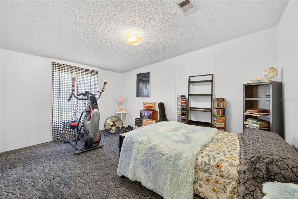 5280 Golddust Road Spring Hill, FL 34609 - Photo 17 of 41 a bedroom with bed and a closet