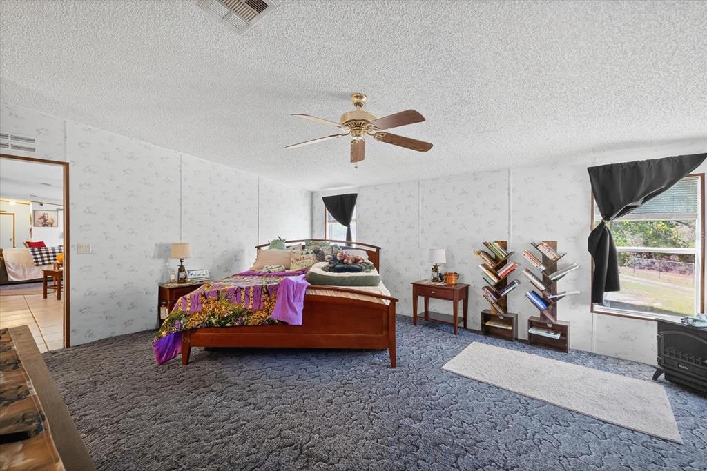 5280 Golddust Road Spring Hill, FL 34609 - Photo 20 of 41 a living room with furniture and a flat screen tv