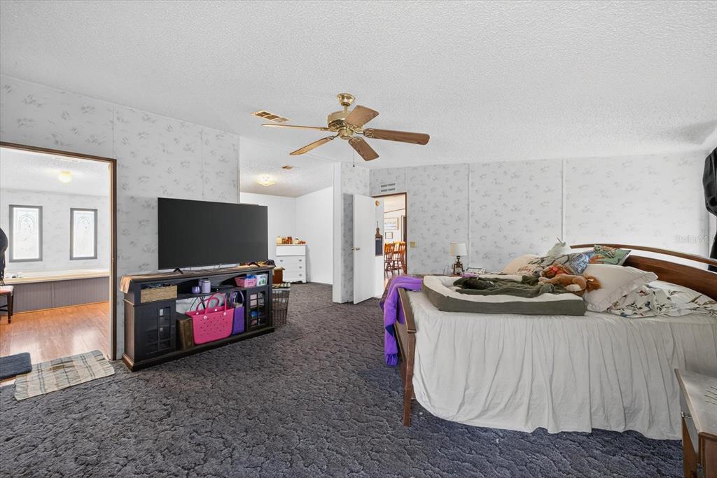 5280 Golddust Road Spring Hill, FL 34609 - Photo 21 of 41 a living room with furniture and a flat screen tv