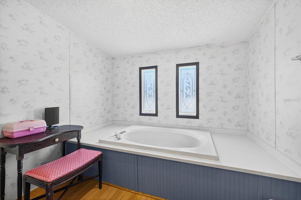 5280 Golddust Road Spring Hill, FL 34609 - Photo 24 of 41 a bathroom with a bathtub sink and toilet