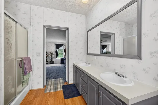 a en suite bathroom with a granite countertop sink and a mirror