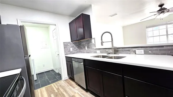 a view with granite countertop a sink and a vanity
