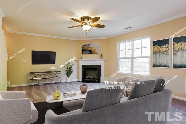 4439 Stonewall Drive Raleigh, NC 27604 - Photo 2 of 27 a living room with furniture and a fireplace
