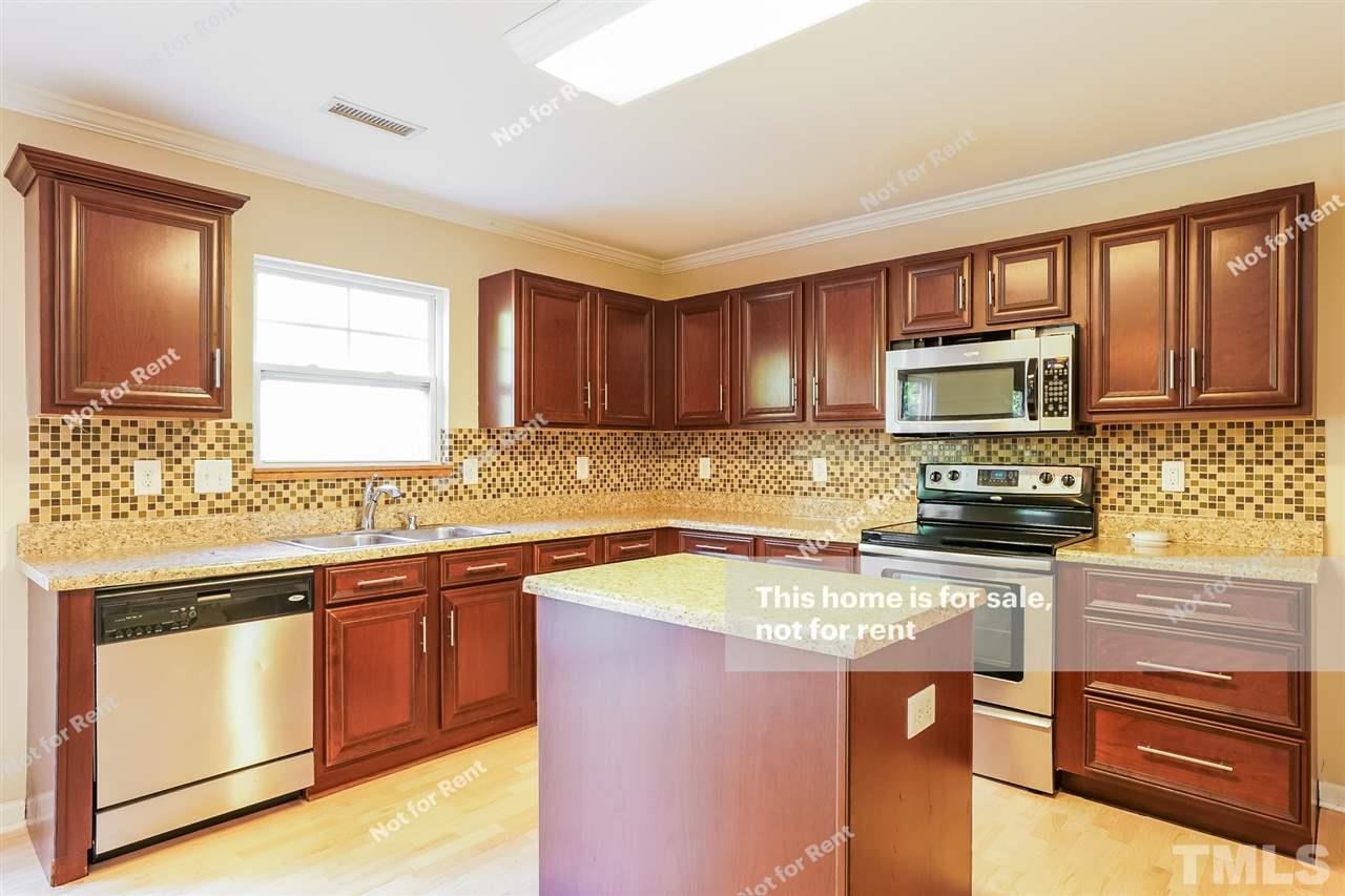 4439 Stonewall Drive Raleigh, NC 27604 - Photo 12 of 27 a kitchen with a sink stove and microwave