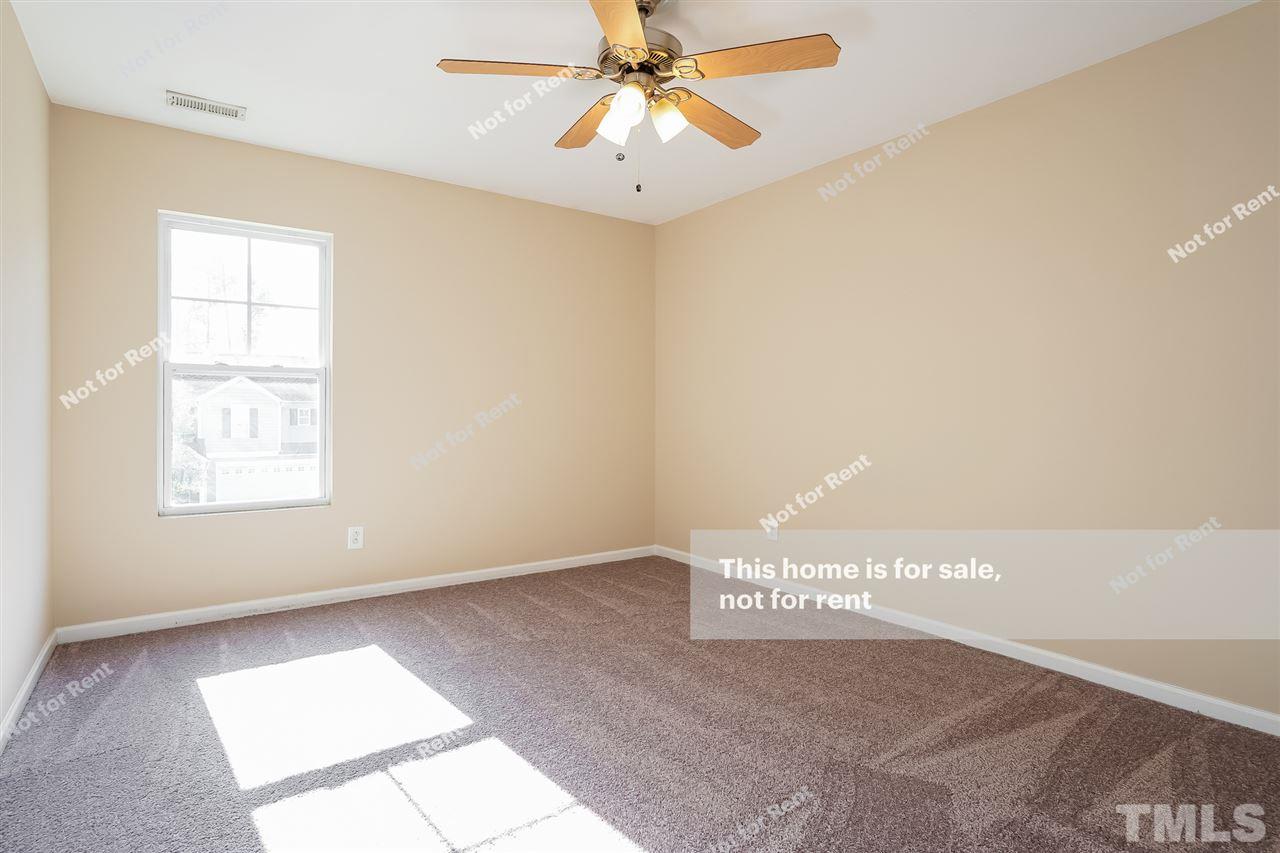 4439 Stonewall Drive Raleigh, NC 27604 - Photo 18 of 27 a view of an empty room and window with a ceiling fan