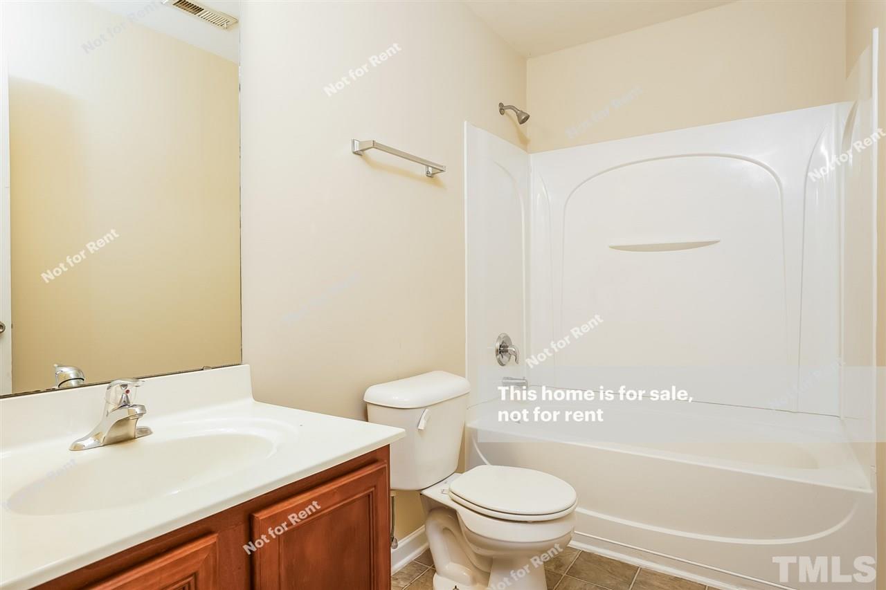 4439 Stonewall Drive Raleigh, NC 27604 - Photo 26 of 27 a bathroom with a sink toilet and shower