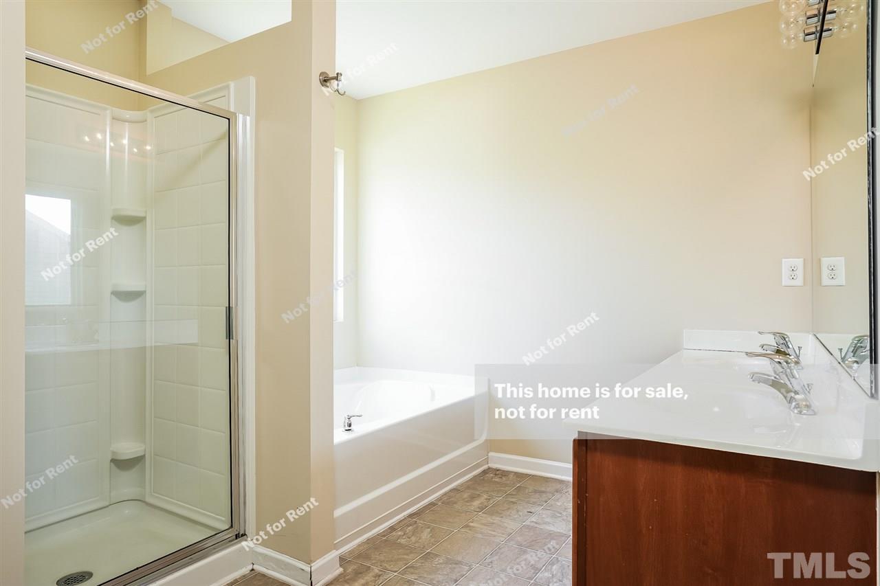 4439 Stonewall Drive Raleigh, NC 27604 - Photo 6 of 27 a bathroom with a sink and a mirror