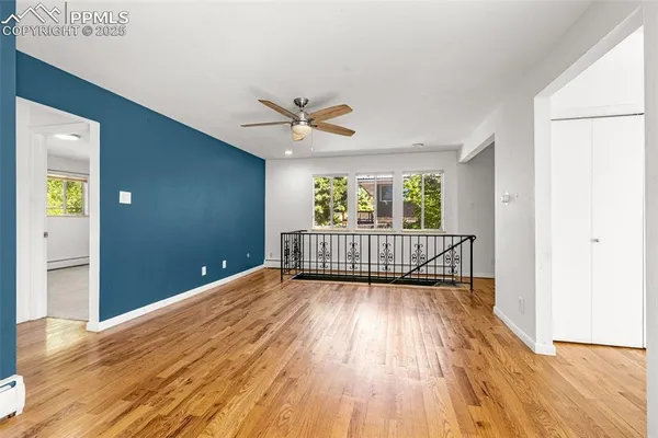a view of a room with wooden floor and a window