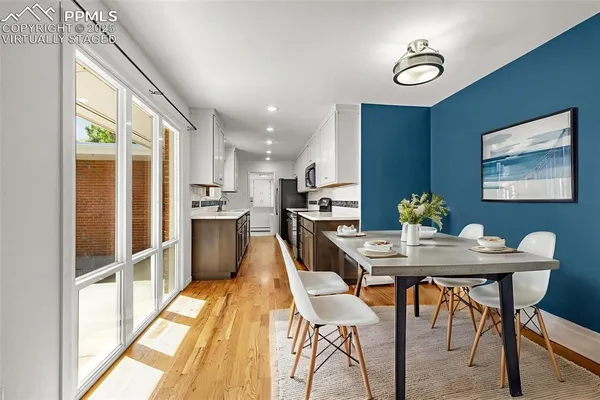 a view of a dining room with furniture window and wooden floor
