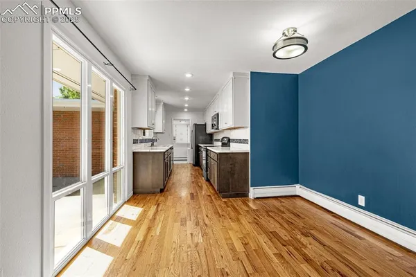 a kitchen with stainless steel appliances granite countertop a refrigerator and a stove top oven
