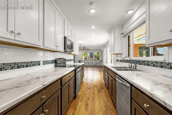 a kitchen with a sink stove and cabinets
