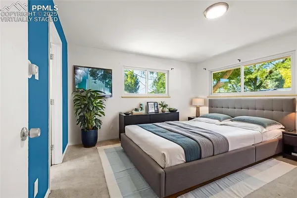 a bedroom with bed and a potted plant