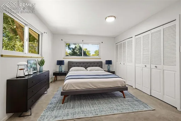a bedroom with a bed window and potted plant