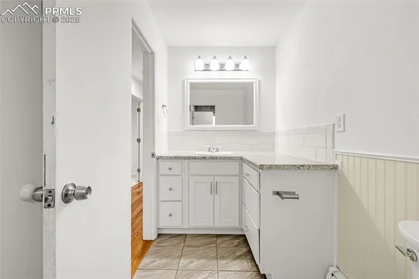 a bathroom with a sink vanity and toilet