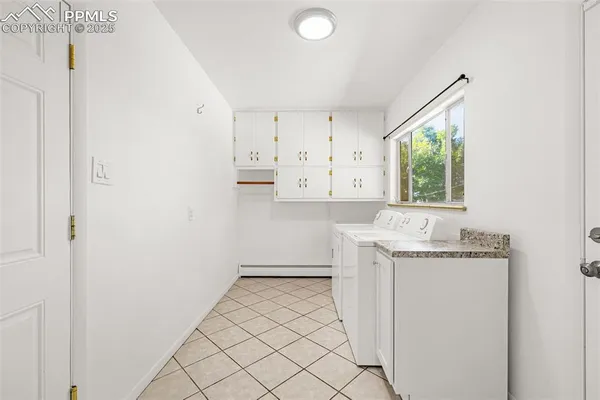 a room with a sink a window and cabinets