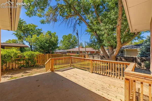 a view of a bench with wooden fence