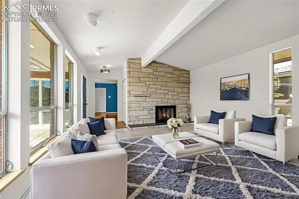 a living room with furniture and a fireplace