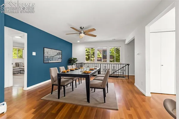 a dining room with furniture a window and wooden floor