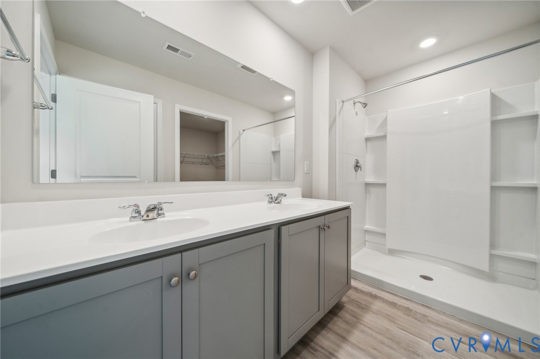 1740 River Vista Road Hopewell, VA 23860 - Photo 18 of 24 a bathroom with a shower sink and mirror