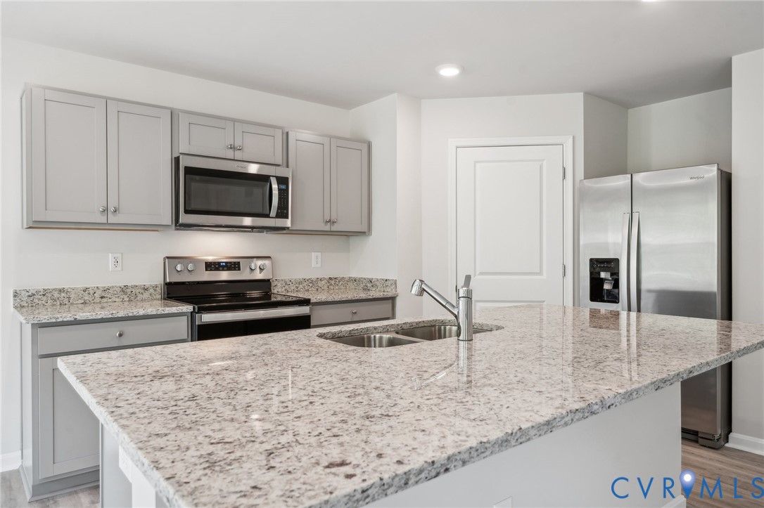 1740 River Vista Road Hopewell, VA 23860 - Photo 6 of 24 a kitchen with stainless steel appliances granite countertop a sink stove and refrigerator
