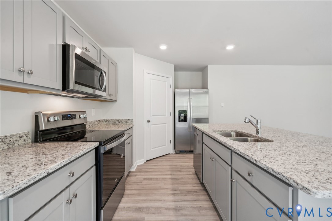 1740 River Vista Road Hopewell, VA 23860 - Photo 7 of 24 a kitchen with stainless steel appliances granite countertop a sink stove microwave and refrigerator