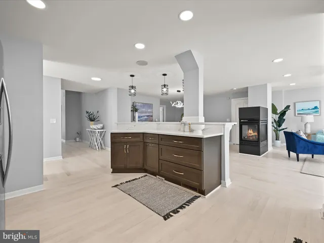 a bedroom with a bed lamp and a large window