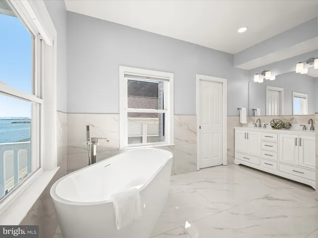 a bathroom with a granite countertop sink a toilet and a mirror