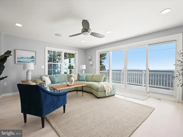 a large kitchen with stainless steel appliances lots of white cabinets