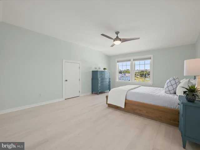 an aerial view of water body with boats and residential houses with outdoor space