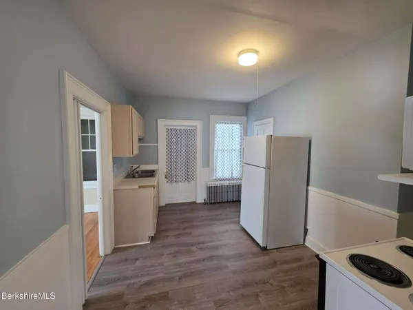 a kitchen with a refrigerator sink and stove