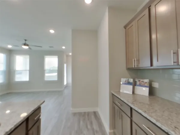 a kitchen with granite countertop white cabinets and white appliances