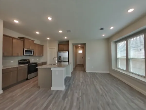 a view of kitchen with sink and wooden floor