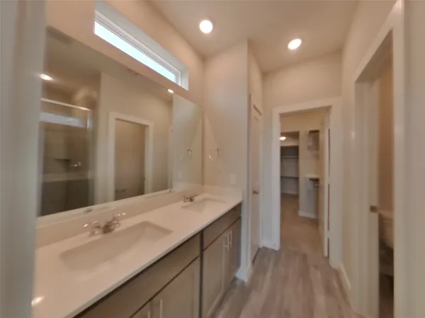 a bathroom with a double vanity sink mirror and shower