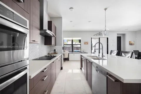 a kitchen with stainless steel appliances a sink stove and cabinets