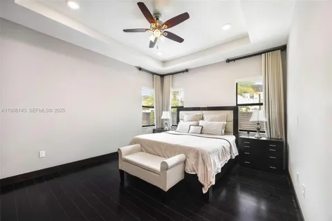 a bedroom with a bed and a ceiling fan