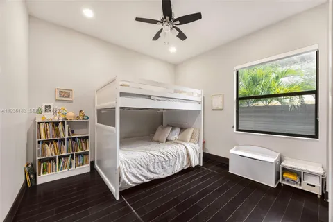 a bedroom with a bed and a bookshelf