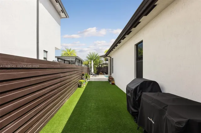 a view of a balcony with yard