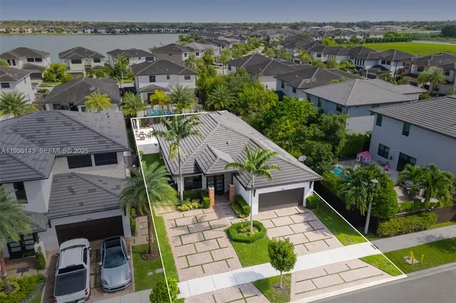 an aerial view of multiple houses with a yard