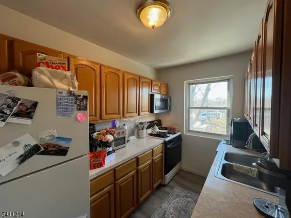 a kitchen that has a sink stove and cabinets