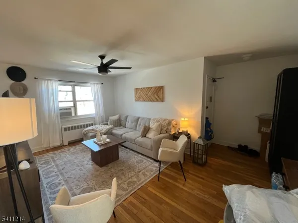 a living room with furniture a window and a flat screen tv