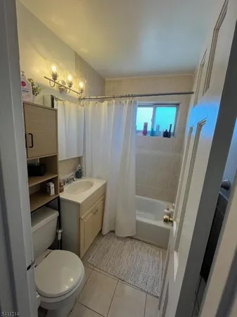 a bathroom with a sink a toilet a mirror a vanity and shower