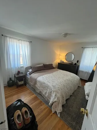 a bedroom with a bed and a lamp on dresser