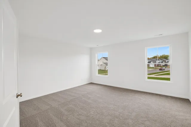 an empty room with windows and wall painting