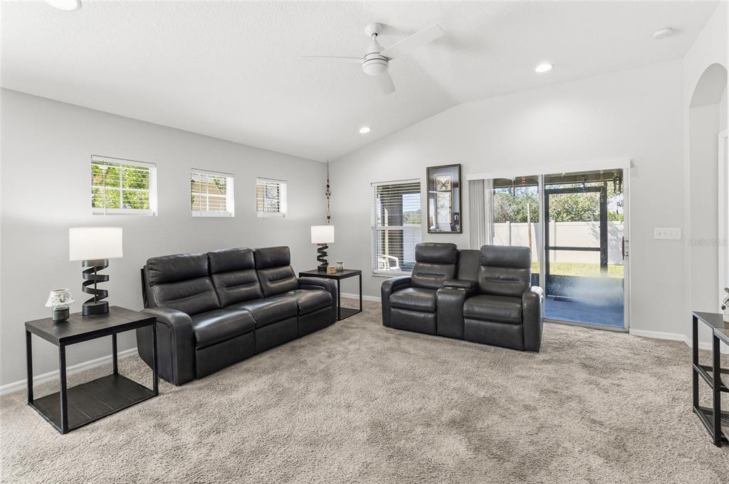 6641 Boulder Run Loop Wesley Chapel, FL 33545 - Photo 18 of 43 a living room with furniture and a flat screen tv